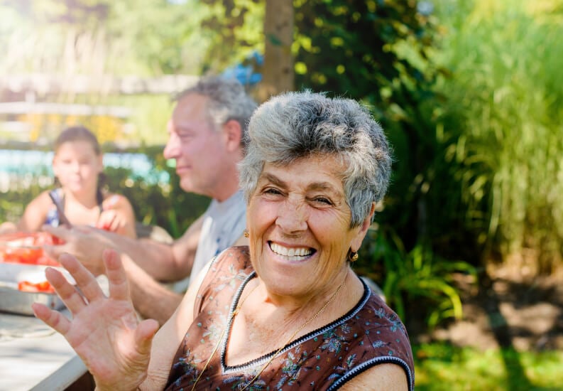 Elderly Woman Enjoying Outdoor Activities with Her Family Near Skilled Nursing Facility Elderly Woman Enjoying Outdoor Activities with Her Family Near Skilled Nursing Facility
