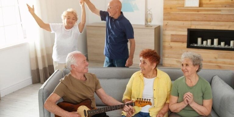 Elderly Group Singing and Dancing in Lounge at Independent Living Facility
